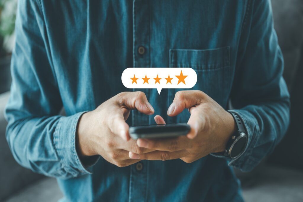 Man holding a phone - with 5 star rating