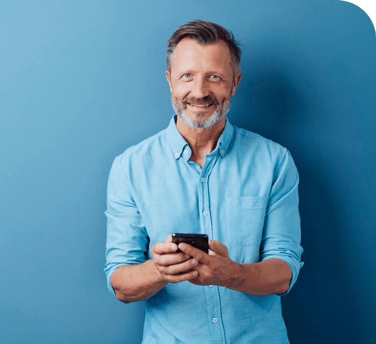 Smiling man holding a phone